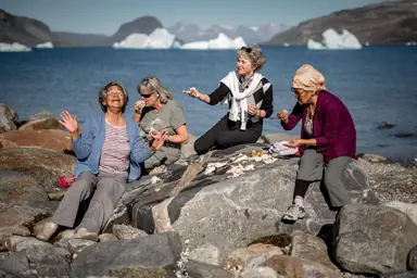 four-women-sharing-fun-stories-at-an-outdoor-meal-in-narsaq-in-south-greenland.png