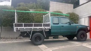 ute-with-long-poles-on-racks-scaled.jpg